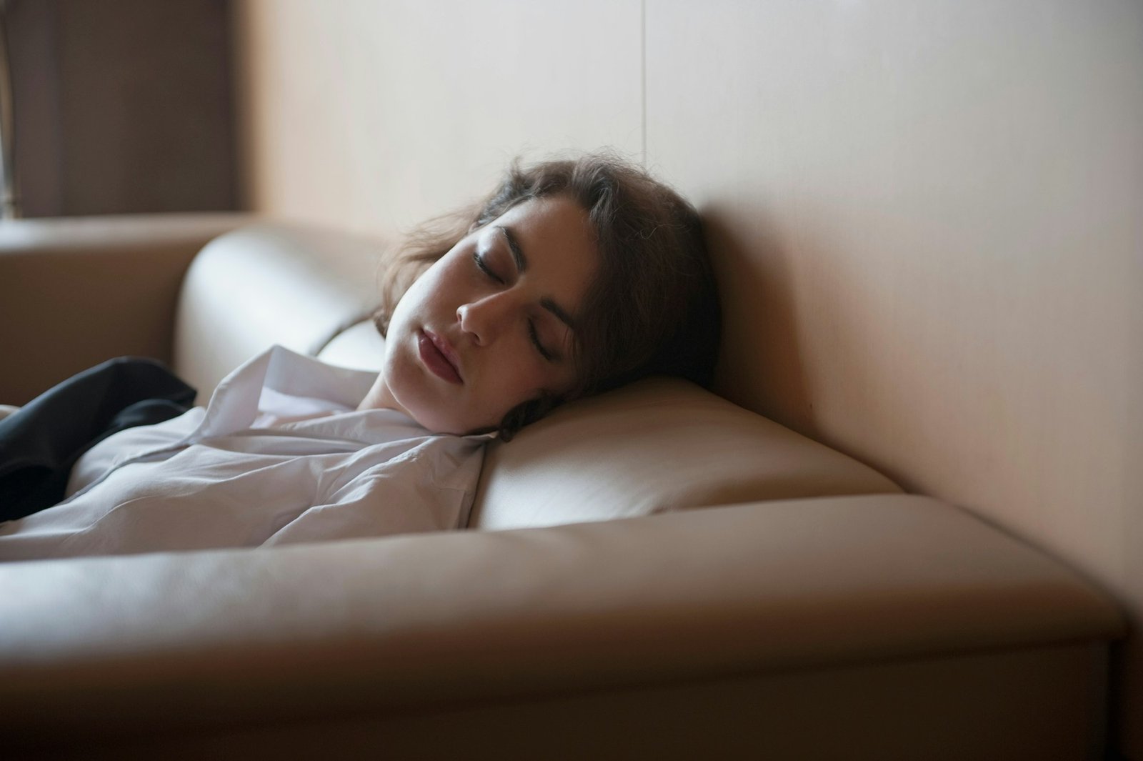 businesswoman sleeping on couch