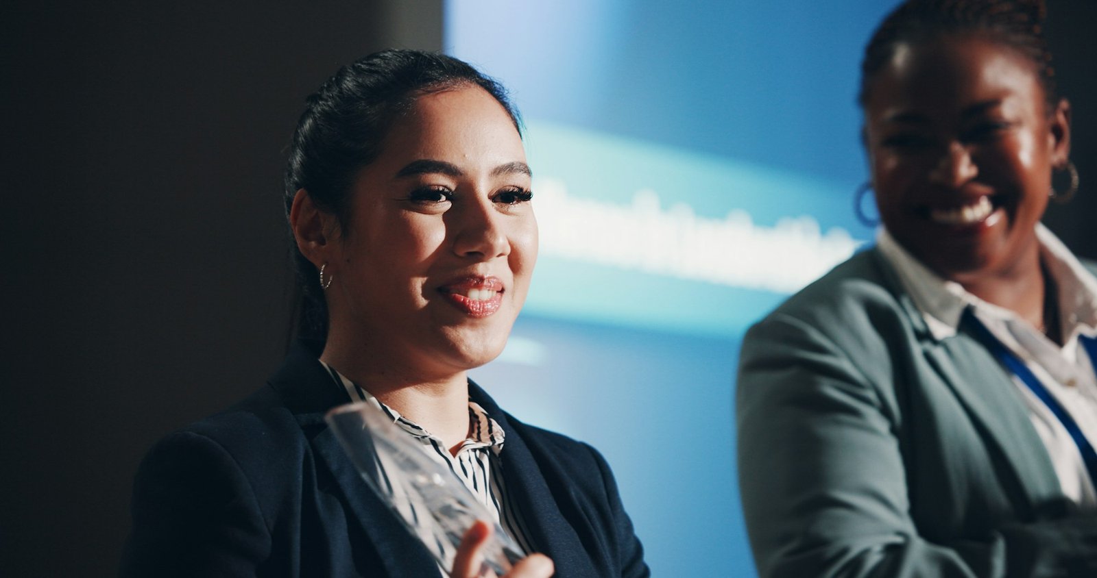 Woman, speaker and introduction at convention, stage or discussion with seminar event for gender eq