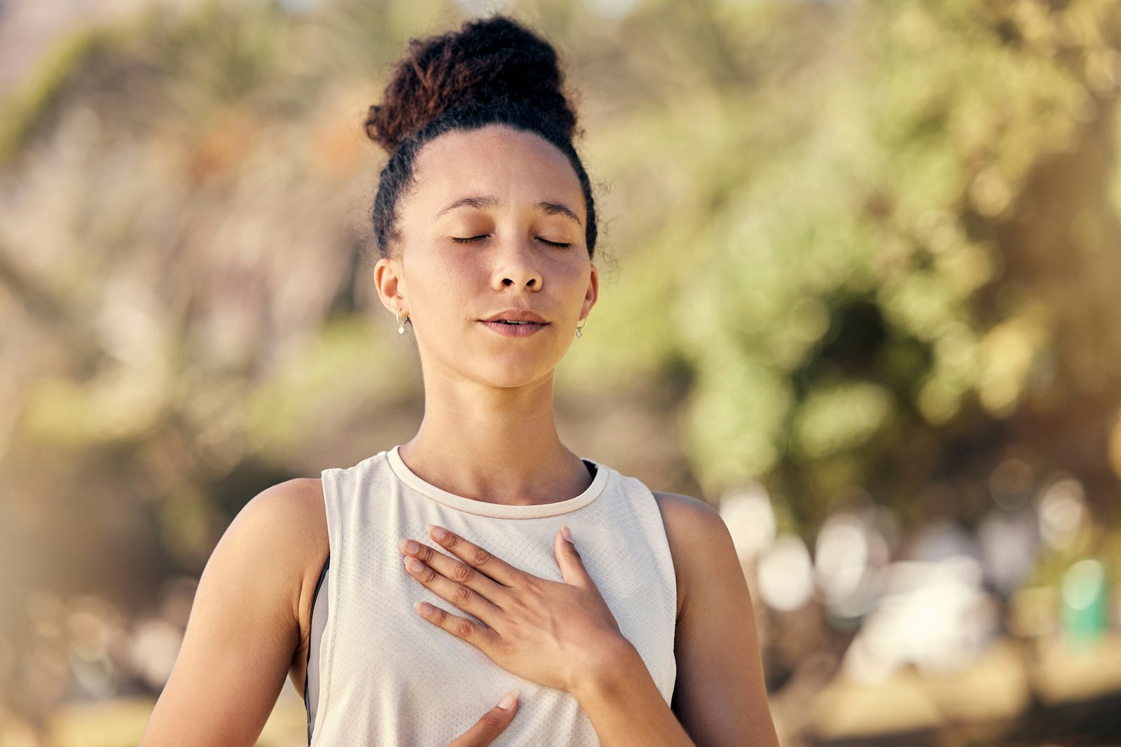 Yoga, meditation and fitness with a black woman breathing for calm exercise outdoor in a nature par